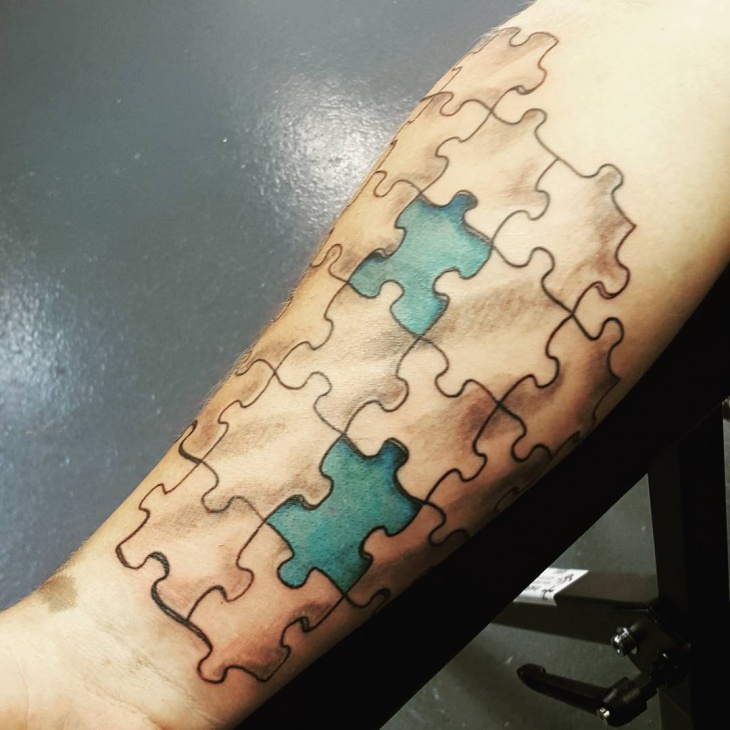 Jigsaw puzzle pieces tattoo