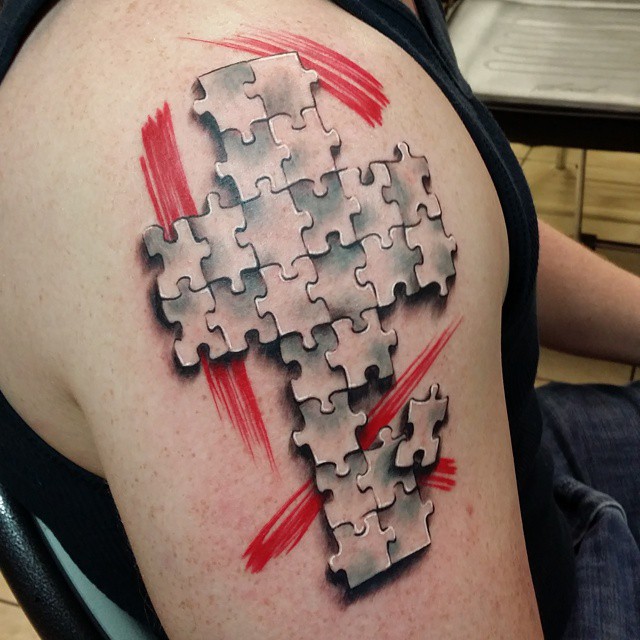 Jigsaw puzzle pieces tattoo